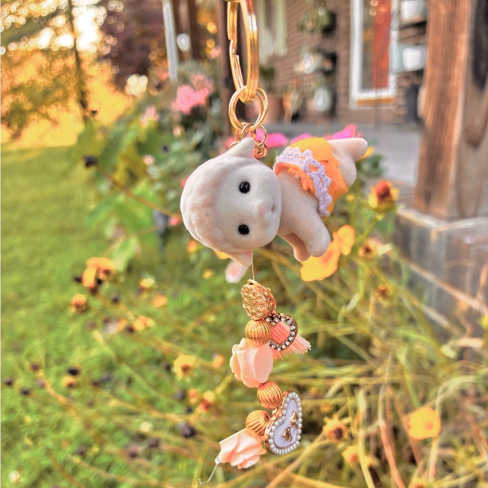 Pink and yellow multiple keychain w/ a sylvanian families calico critter toy